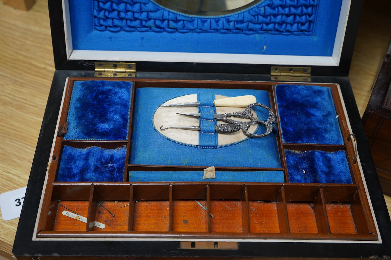 Three 19th century vanity and sewing boxes with fitted interiors to include a mother of pearl inlaid example with glass bottles, jars and mirror, largest 35cm wide. Condition - fair, some losses